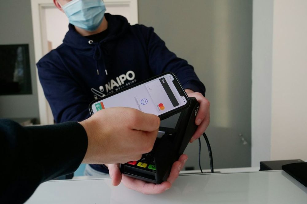 Customer paying by card at a shop counter